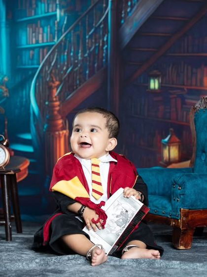 This little wizard is enjoying a good book in the common room, with a look of pure joy.