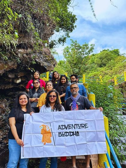 Our group holding the Adventure Buddha banner at a waterfall in Chikmagalur. We are proud to share these amazing places with our community.
