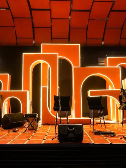 The stage setup for the live band, featuring bold, illuminated orange arches. This created a visually stunning focal point for the entertainment part of the evening.