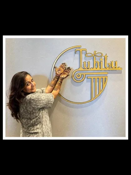A happy client posing with her beautiful Teej mehendi.