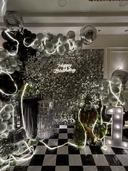 A different angle of the disco party setup, highlighting the layered details like the LED light strips woven through the balloons and the reflective disco balls that catch the light.