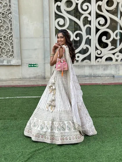 A full view of this gorgeous daytime look. The soft, flowing hair and natural makeup allow the intricate details of her outfit and her happy smile to be the main focus.