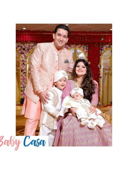 A beautiful family celebrating Lohri in coordinated outfits. The little boys are wearing our custom white and gold ethnic sets, looking like little princes.