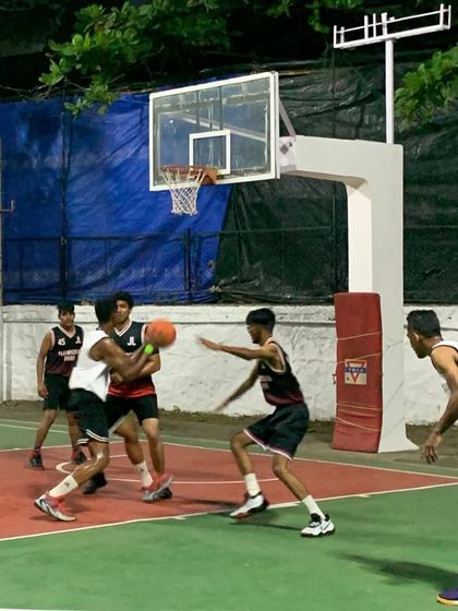 Dominating the court one basket at a time. Here, a player makes a strong move to the hoop against multiple defenders.