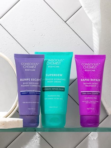 A classic "shelfie" shot. We placed these colorful body care products on a glass shelf in a tiled bathroom setting to create a relatable and aspirational image of a well-curated routine.