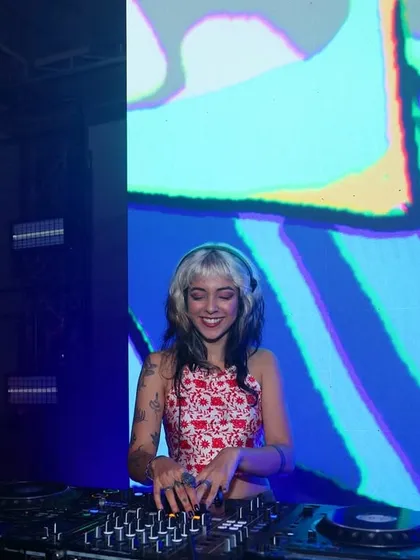 A big smile for the camera while DJing. It's supposed to be fun, after all.
