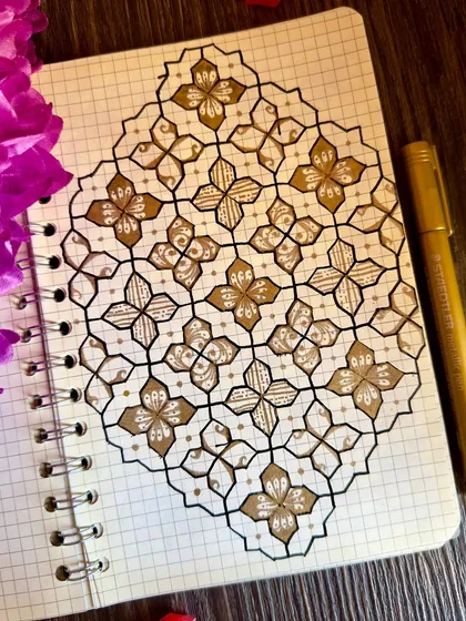 A simple yet elegant pattern in gold and black. Using a grid book helps me maintain the precision of these geometric designs, while the touch of gold adds a little bit of sparkle.
