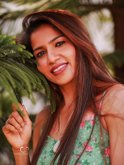 A bright and joyful smile that radiates warmth. This close-up portrait in nature feels fresh, happy, and full of life.