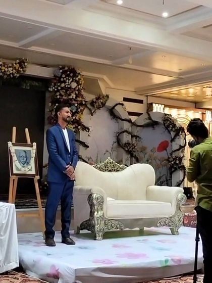 A moment on stage after the performance in Amravati, with the final sand portrait gifted to the family on an easel.