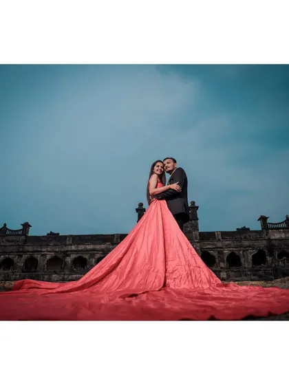 A breathtaking pre-wedding portrait at a historic fort, creating a cinematic moment with a dramatic, flowing gown against a grand architectural backdrop.
