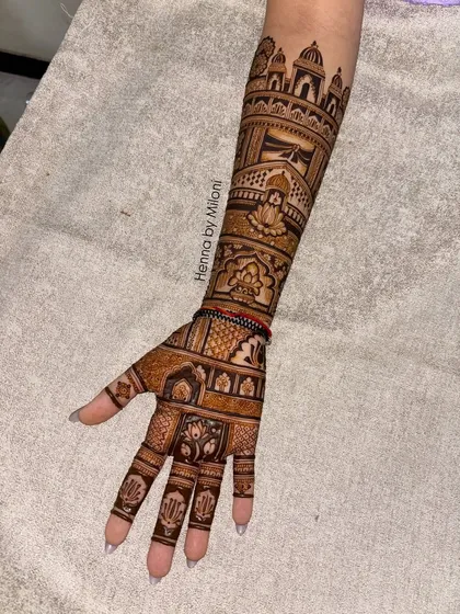 A beautiful bridal mehendi without any figures, focusing purely on architectural and floral patterns. This design features a prominent Mumbai skyline on the forearm.
