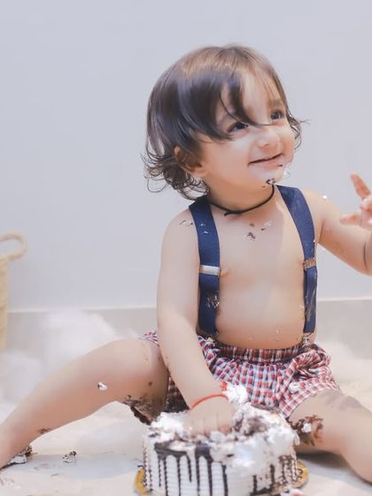 A happy smile covered in cake. These candid shots are what make cake smash photography so special and memorable.