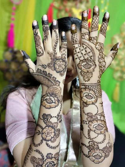 A playful pose showing off a very detailed floral design that covers the hands and forearms. I love how the flowers and leaves seem to dance up the arms.