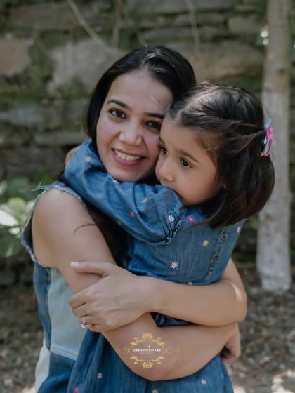 A warm hug between a mother and her daughter, capturing their close bond in a natural outdoor setting.