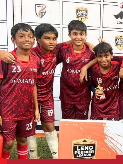 The U-10 team celebrates with their Player of the Match trophy, showcasing their success in the league.