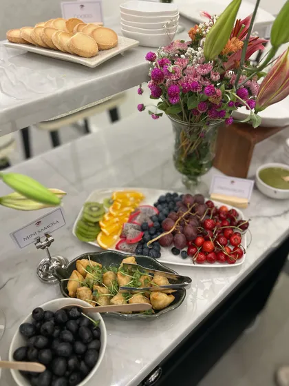 Another shot from the store opening, showcasing our fresh fruit platter and mini samosas. We aim to provide a balanced menu with both healthy and indulgent options.