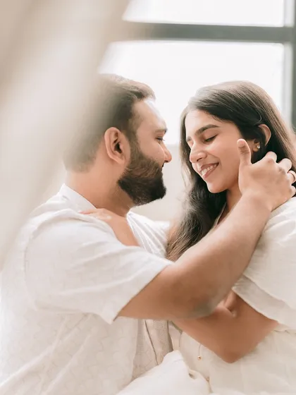 A close-up shot from an intimate studio session, focusing on the gentle expressions and connection between the couple.