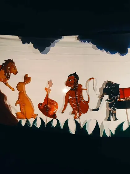 A full scene from our Chitrakathi show, featuring a lineup of handcrafted leather puppets. Each character, from the lion to the monkey, is intricately detailed, showcasing the incredible artistry of this folk tradition.