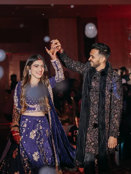 The couple shares a dance during their Sufi night, lost in the music and each other. The soft lighting and bubble effects add to the dreamy atmosphere.
