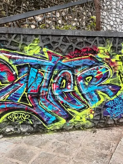 A colorful piece on a stone wall, showing how I adapt my lettering style to fit the texture and shape of the surface.