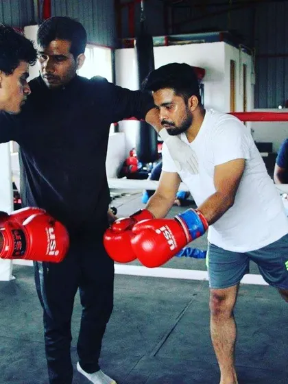 Hands-on coaching is key to our method. Here, we are in the ring, refining boxing techniques and footwork with students during a striking session.