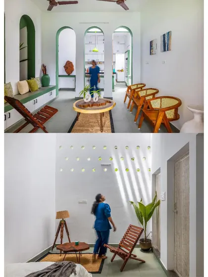 The interior of the 'House of No Windows' is bright and airy, with green-painted arches defining spaces and light filtering in from above.
