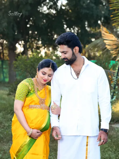 A tender moment between a couple during their outdoor traditional shoot. The natural light and their loving embrace create a warm and intimate portrait.