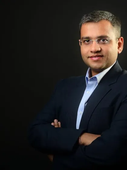 A classic corporate headshot against a solid dark background. This style provides a clean, timeless, and professional look, ideal for LinkedIn profiles, company directories, and speaker bios.