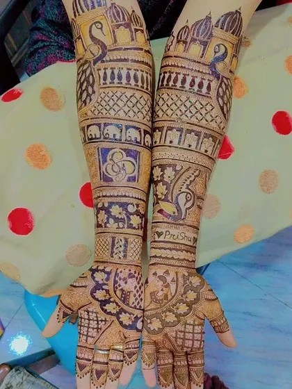 This design combines peacocks and elephants with a personalized 'PreeShu' heart and the symbol for 'faith'.