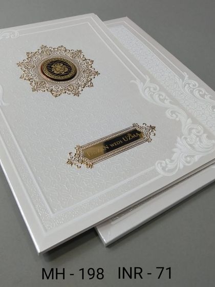 This formal white invitation features an embossed border and a prominent gold and black nameplate. The design is classic and suitable for a Nikkah or Walima ceremony.
