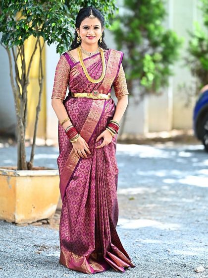 A full-length view of the magenta Kanchivaram ensemble, perfect for a wedding guest or for a festive occasion.