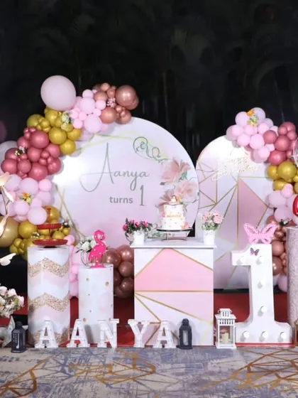 An elegant outdoor butterfly-themed first birthday party, with a beautiful pink, rose gold, and gold color palette.