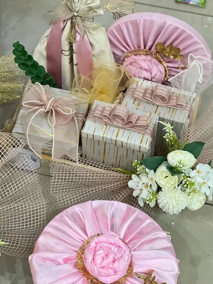 A wedding hamper designed with a dreamy mood board in mind. The soft pink and cream color palette, combined with delicate ribbons and floral touches, creates a romantic and elegant feel.