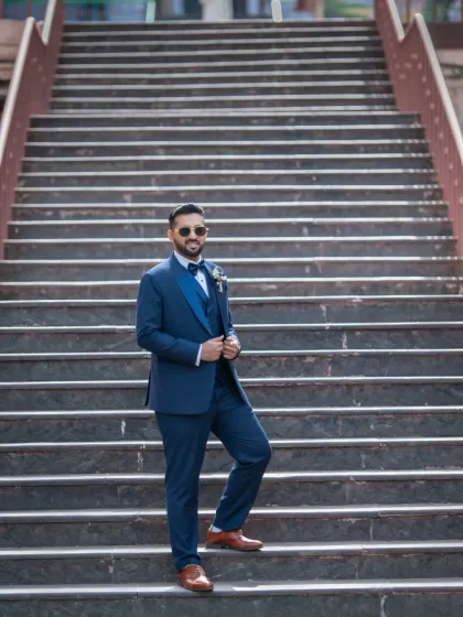 Using the strong leading lines of the staircase to create a dynamic and stylish portrait of the groom.