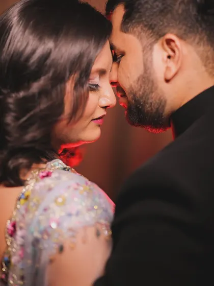 A very close and intimate portrait, capturing the moment just before a kiss. This tight framing emphasizes the emotional connection and chemistry between the couple, making it a powerful and romantic shot from their celebration.