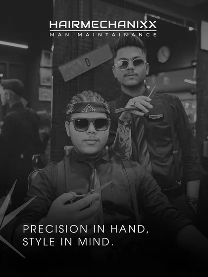 Precision in hand, style in mind. This image captures the cool, confident attitude of our stylists, ready to craft your next look.