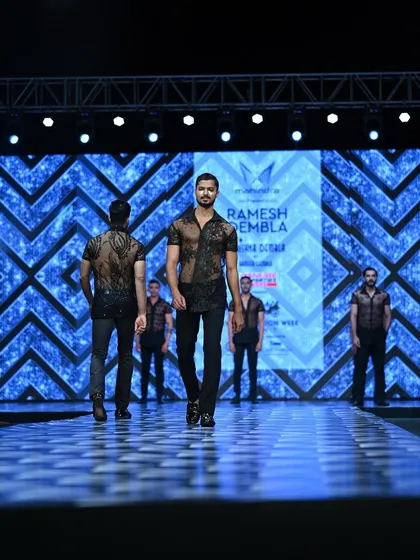 Leading a line of models on the ramp for Ramesh Dembla's show, a moment that requires precision and leadership.