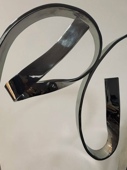 This detail shot shows the clean, flowing lines and the mirror-like finish of the stainless steel used in "The Bond."