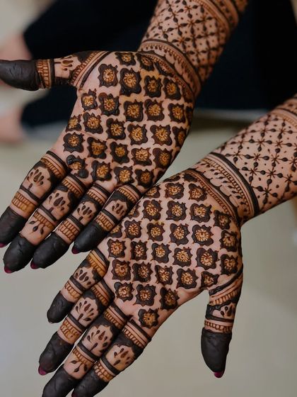 Another look at the precision of grid work. Each square is filled with a delicate floral buti, creating a uniform and captivating pattern on the palm.