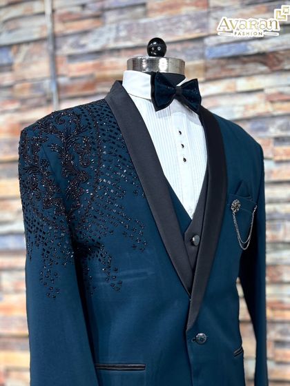 The detailed sequin and beadwork on the shoulder of our teal blue suit is designed to catch the eye.