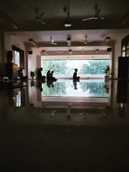 A silhouette of practitioners in meditation. It is a blessing to be in stillness and practice together as a community.