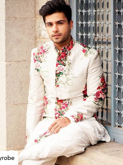 A fresh and floral look for him. This white bandhgala jacket with vibrant red floral embroidery is perfect for a day event.
