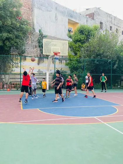 A player takes a jump shot from the baseline.