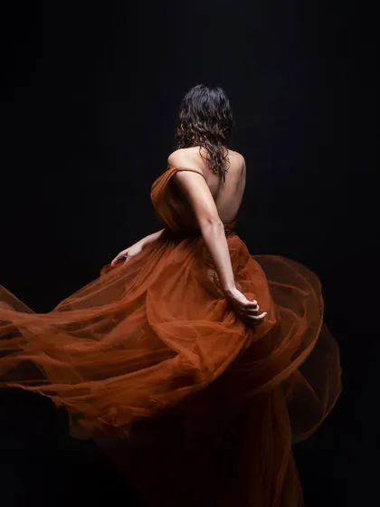 Another angle of the flowing tulle shot, highlighting the texture of the wet-look hair and the way it catches the light. This is a key element of creating successful editorial looks.