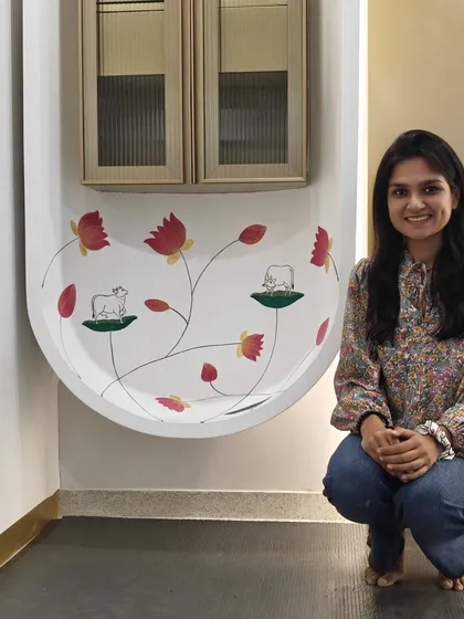 Posing with my completed Pichwai mural in the office. The minimalist style was chosen to align with the classy, modern design of the workspace.