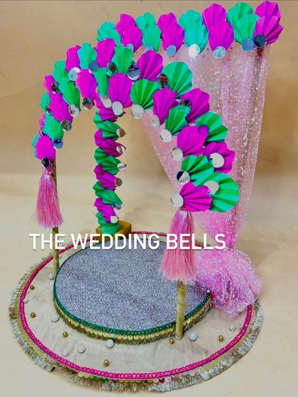 Another angle of our popular pink and green Ganesha mandap. The arch is decorated with mirror-work and tassels, adding a touch of traditional Rajasthani flair to the design.