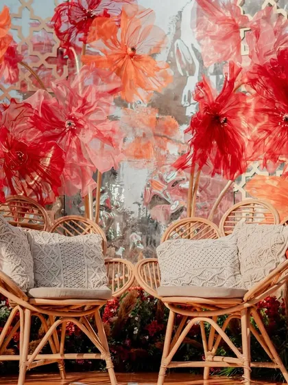 A close-up of the chic rattan seating on the stage, adorned with macrame cushions for that perfect boho touch.