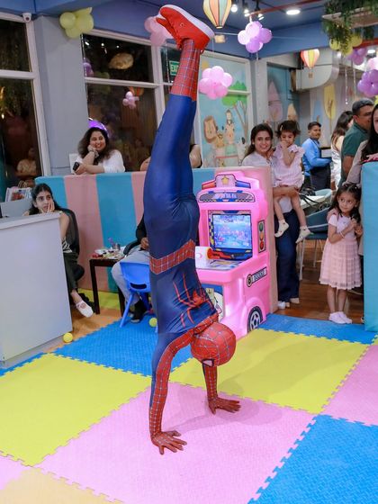 Our Spider-Man doesn't just stand there, he performs. Here he is showing off his acrobatic skills on our soft play-mat floor, amazing the kids and parents watching the show.