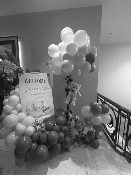 The welcome entrance for a teddy bear themed baby shower, featuring a custom welcome sign and balloon arrangements to greet guests as they arrive.