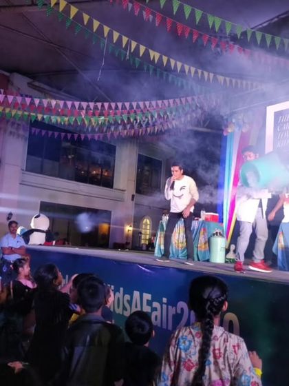 A wide shot of our stage setup at a kids' carnival at Phoenix Market City. The smoke, lights, and engaged crowd show the professional and high-energy production we bring to every event.